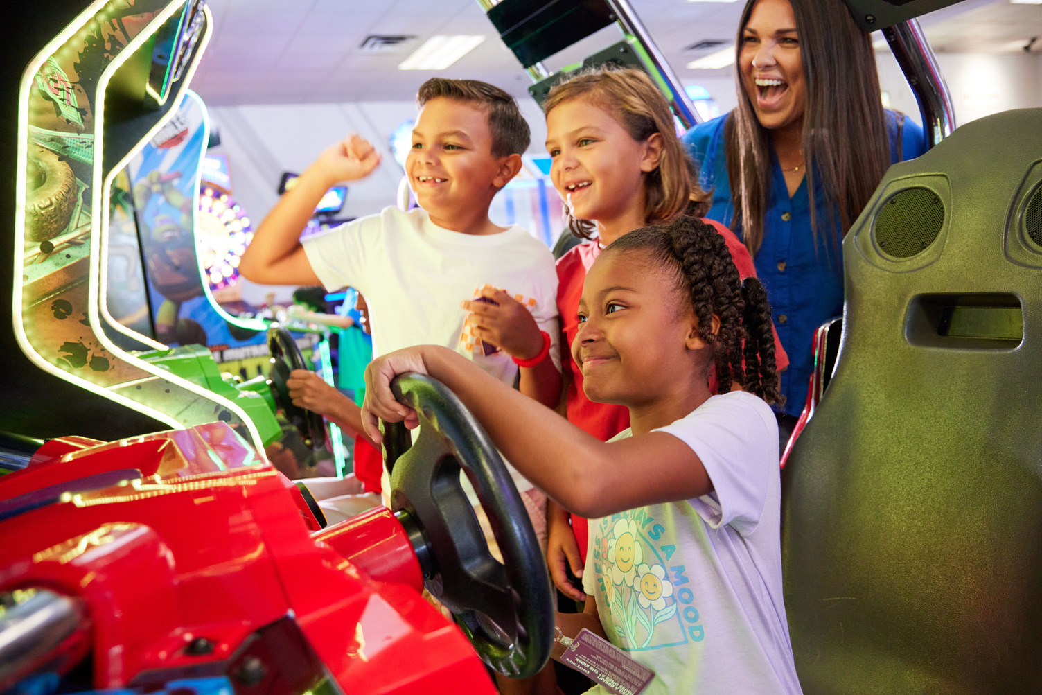 girl driving a race car with friends cheering her on