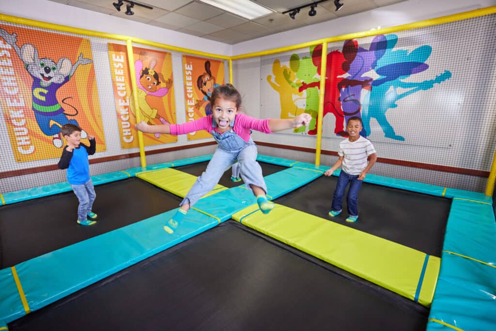 young kids jumping on trampolines
