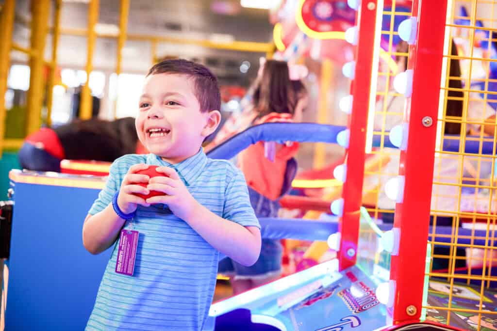 Young boy holding red ball