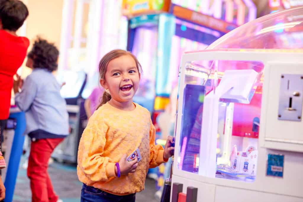 young girl playing arcade games