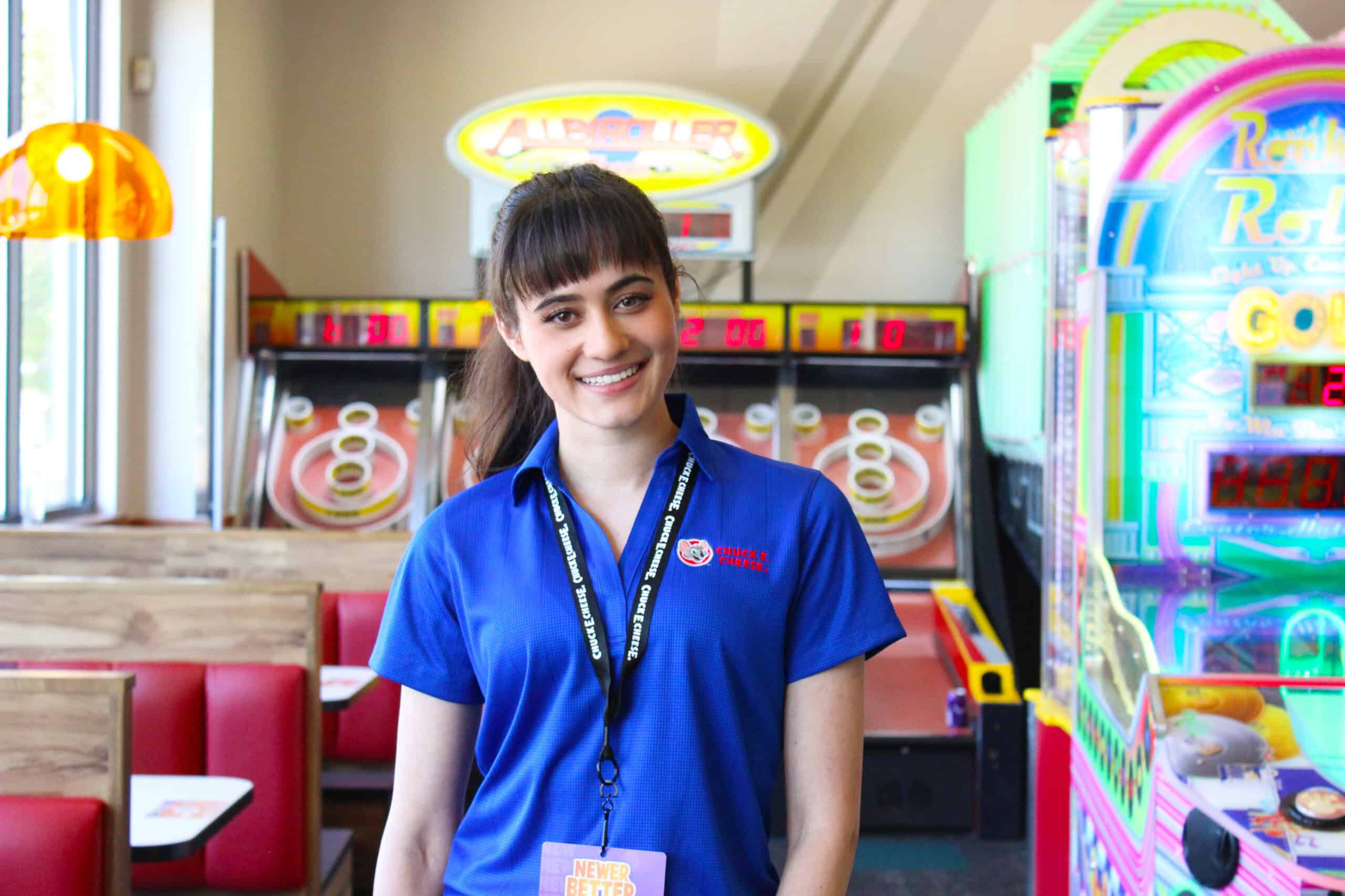 chuck e employee interacting with kids at prize counter