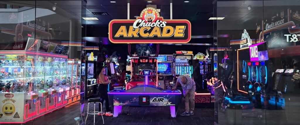 Chuck E. Cheese arcade with air hockey, kids games, neon lights; Fun Pass for birthday parties, pizza and games at family fun center.