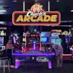 Chuck E. Cheese arcade with air hockey, kids games, neon lights; Fun Pass for birthday parties, pizza and games at family fun center.