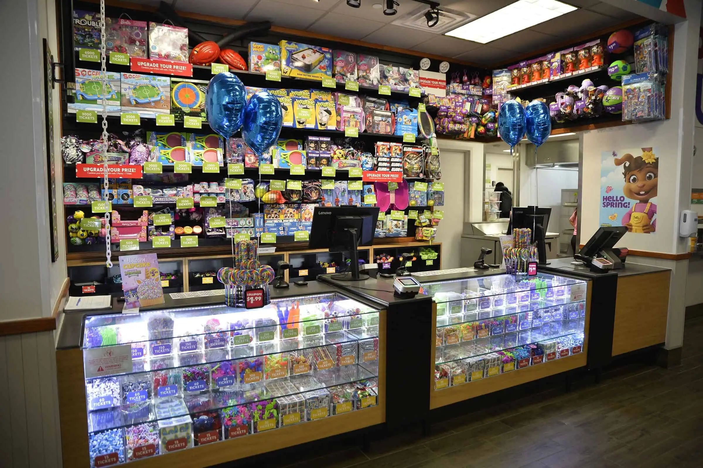 Refreshed Chuck E. Cheese prize counter filled with toys, plush, and candy