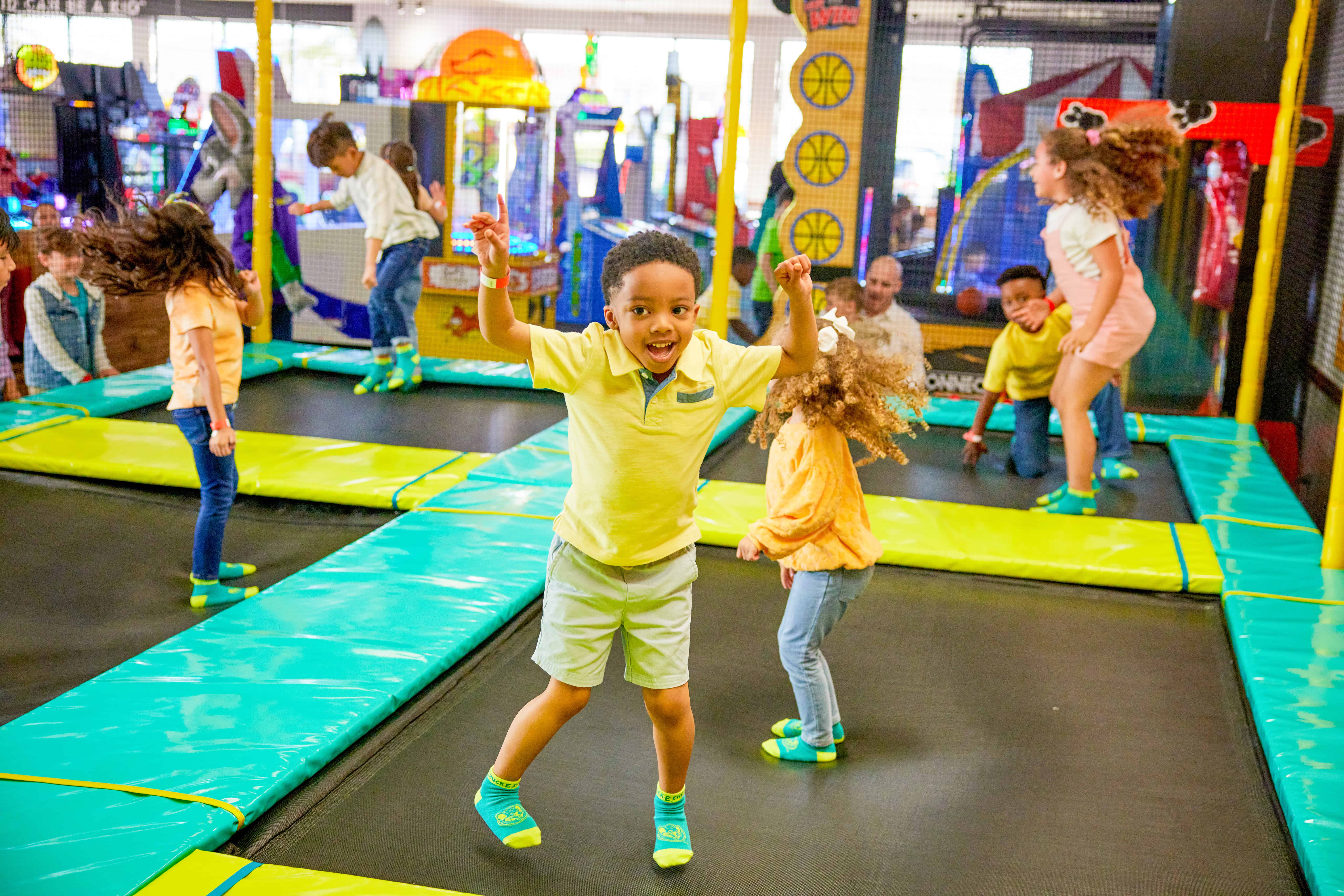 Kids jumping on trampolines in the Adventure Zone at Chuck E. Cheese