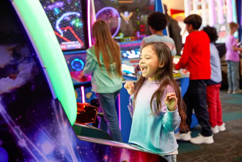 Boy playing a new arcade game at Chuck E. Cheese