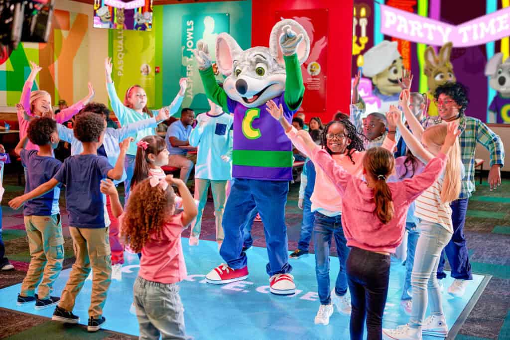 Kids dancing with Chuck E. Cheese on the new interactive dance floor