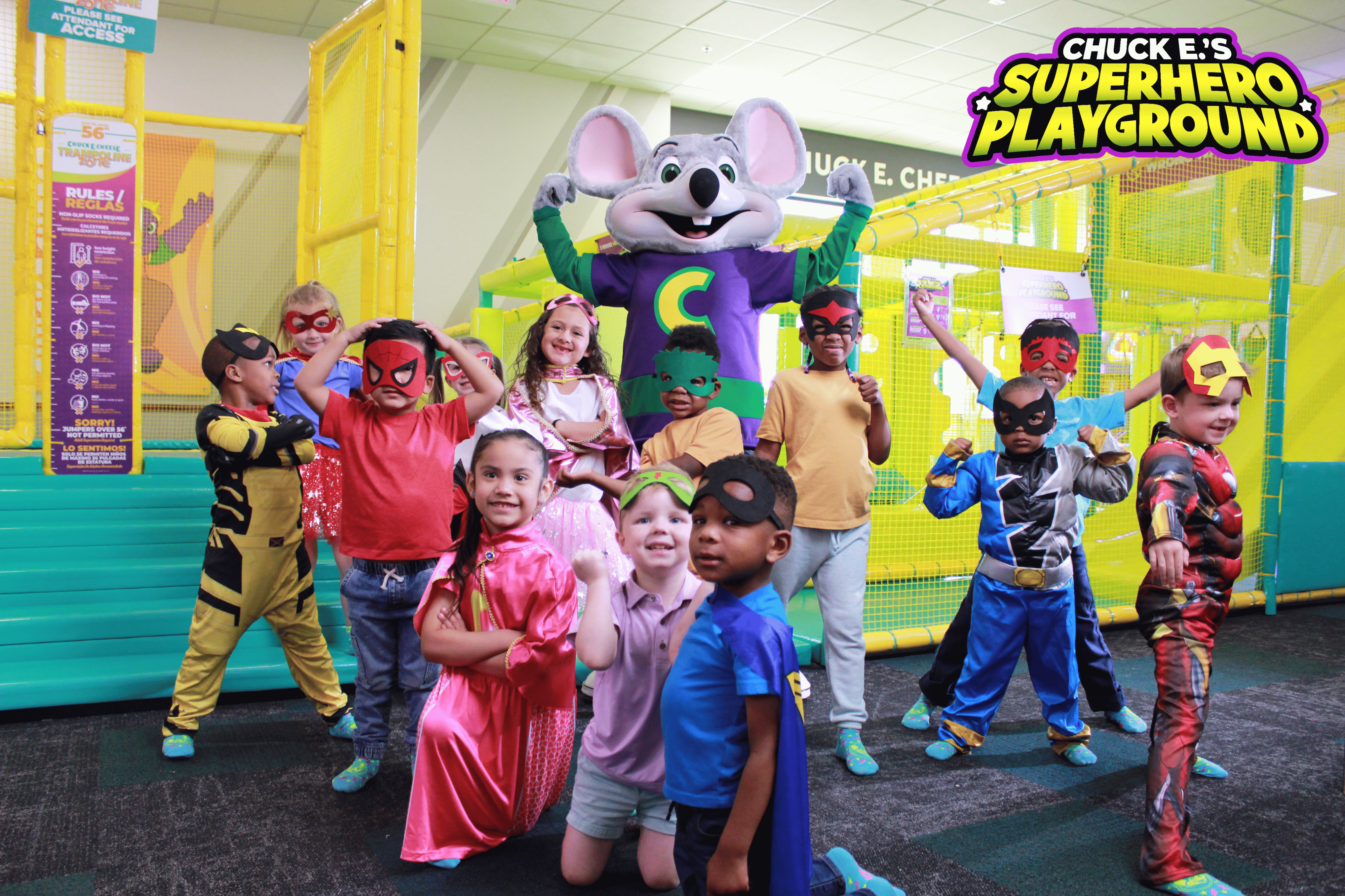 Children in superhero costumes with Chuck E. Cheese at the Superhero Playground