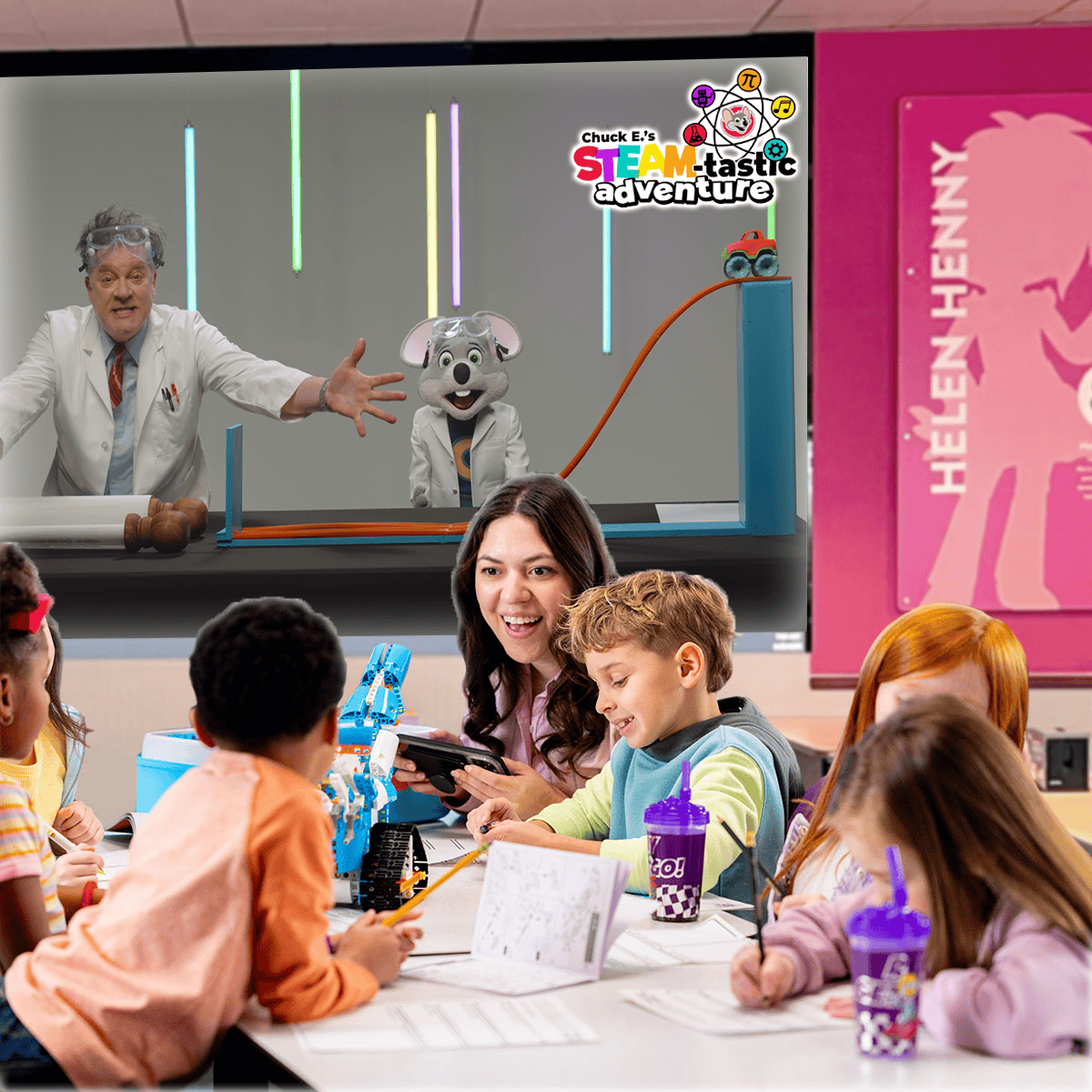 Kids doing STEAM activities with a teacher at Chuck E. Cheese near arcade games