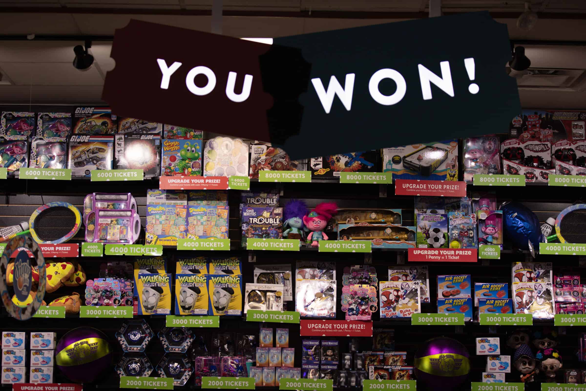 Prize counter at Chuck E. Cheese with a YOU WON sign during Sensory Sensitive Sundays