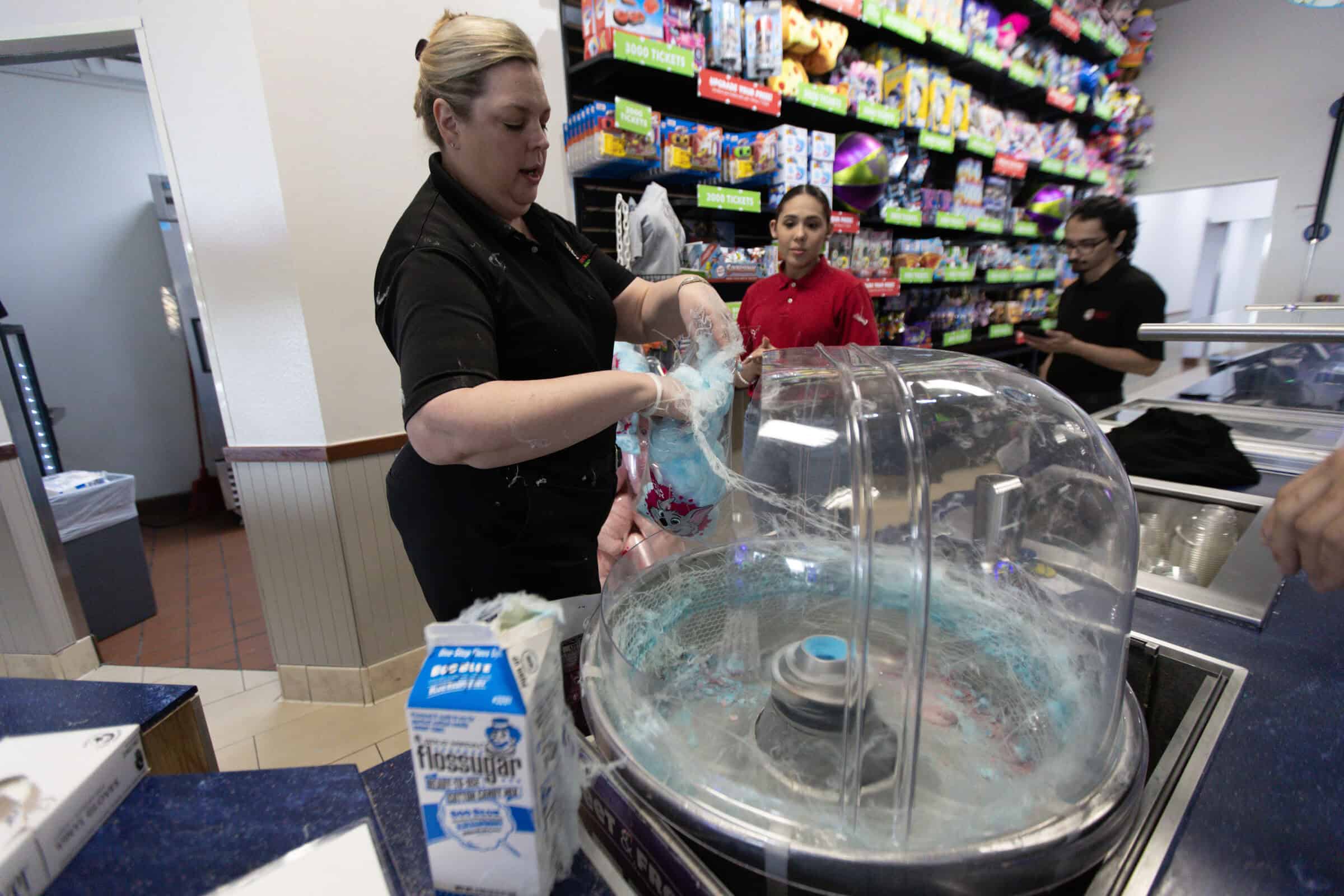 Chuck E. Cheese team member making blue cotton candy at a Sensory Sensitive Sunday event