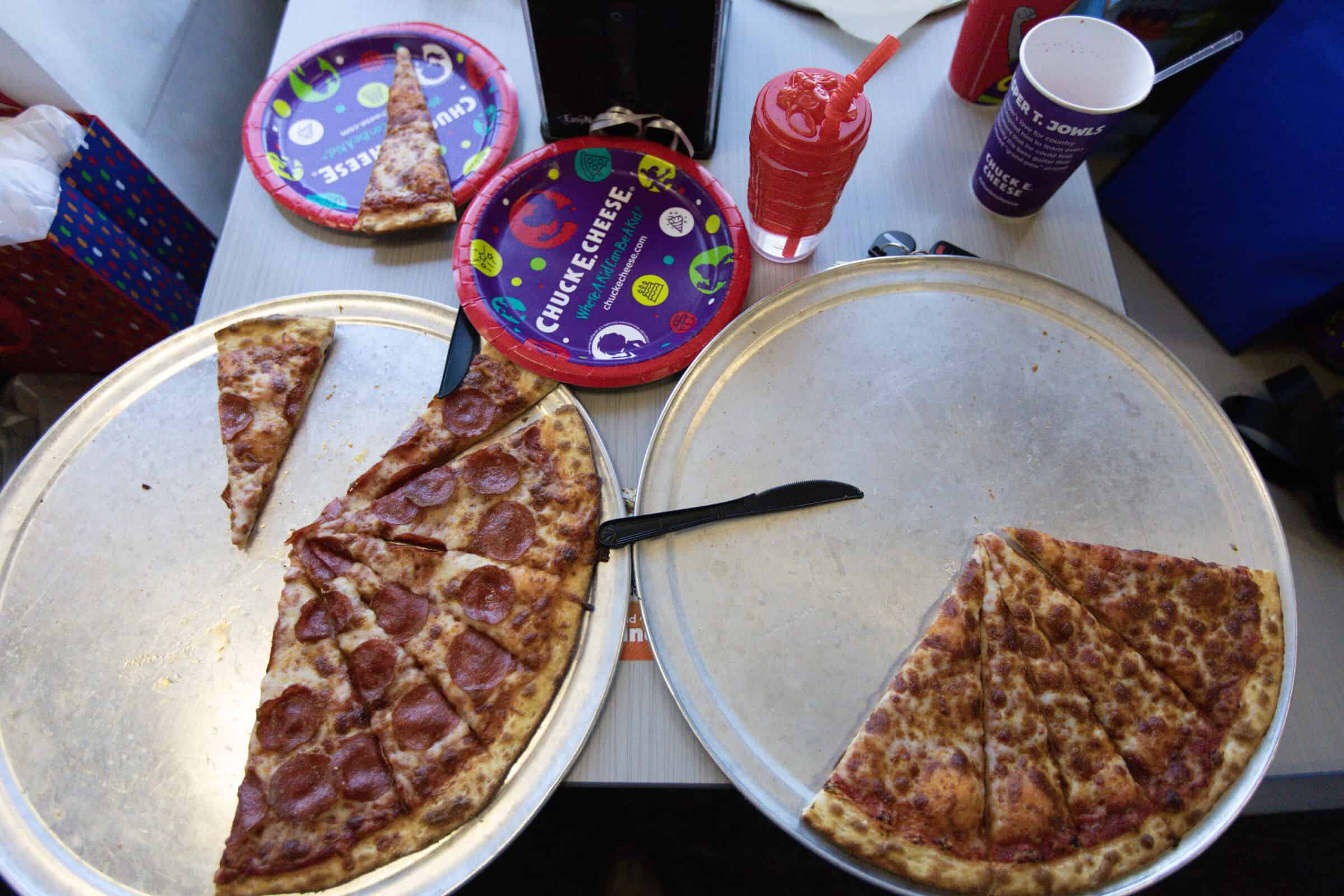 Two Chuck E. Cheese pizzas, pepperoni and cheese, ready to serve