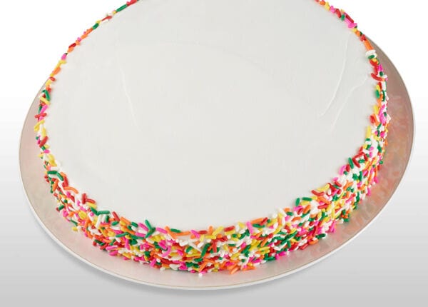 Birthday cake with white icing and rainbow sprinkles served at a Chuck E. Cheese birthday party