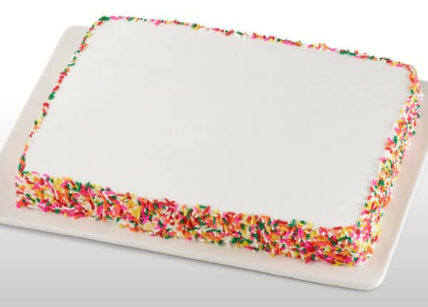 Rainbow sprinkle sheet cake on a white tray, served in the Chuck&nbsp;E.&nbsp;Cheese party room.