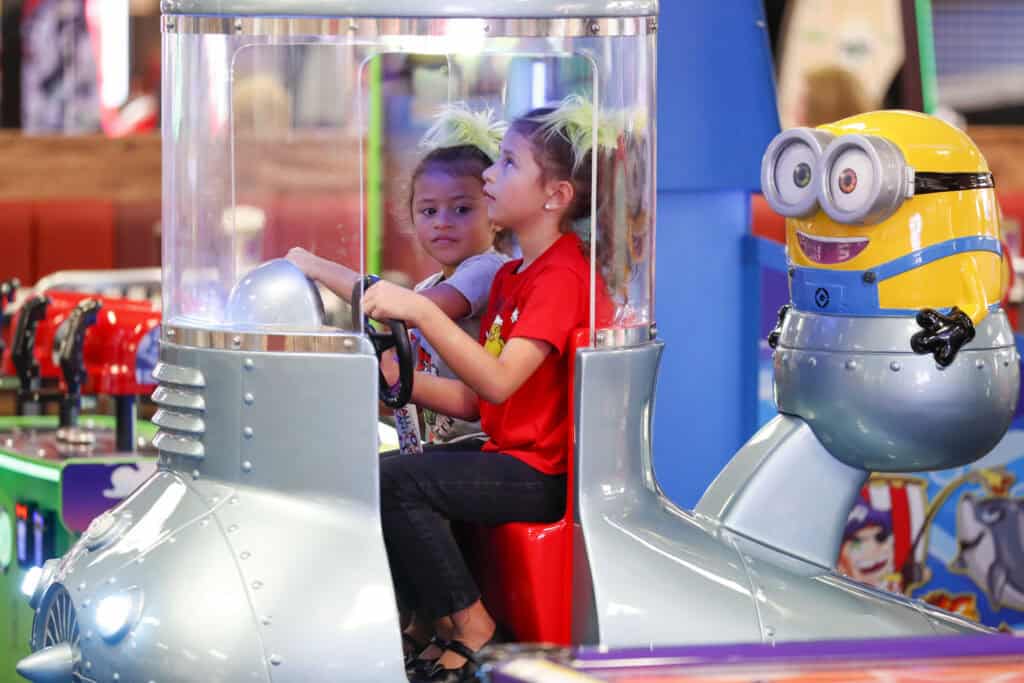 Kids playing together in an arcade game at Chuck&nbsp;E.&nbsp;Cheese.